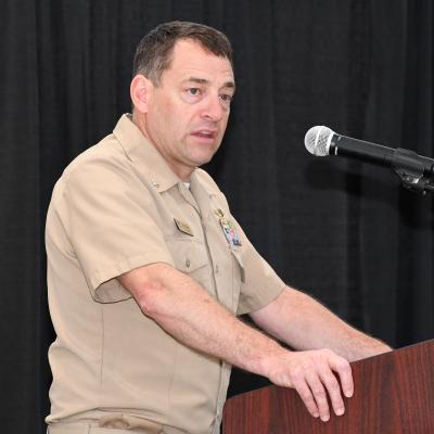 Man speaks from behind lectern