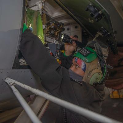 Maintenance on an F/A-18E Super Hornet in USS Gerald R. Ford's (CVN 78) hangar bay