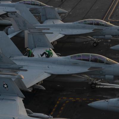 Sailors conduct maintenance on an F/A-18F Super Hornet, from the "Fighting Redcocks" of Strike Fighter Squadron (VFA-22), on the flight deck of USS Nimitz (CVN 68) 