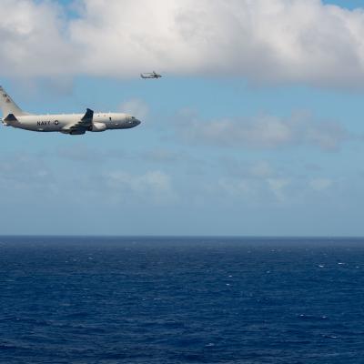 P-8 airplane flies over open ocean