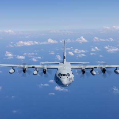 KC-130J Super Hercules Airplane Flying in a Blue Sky with Clouds