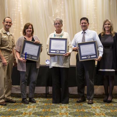 Winners of the Business Management Excellence Individual Award accept their certificates from Rear Adm. Scott Dillon, NAWCWD commander, and Joan Johnson, NAWCWD executive director, during the 2019 Honorary Awards Ceremony at China Lake on June 25. (U.S. Navy photo by Ryan Smith)