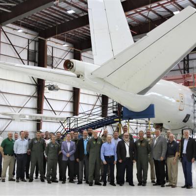 Group standing front of the E-6B Mercury prior to its delivery back to the Navy.