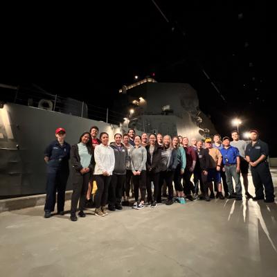 Group of people standing in front of Battle Stations 21 ship simulator