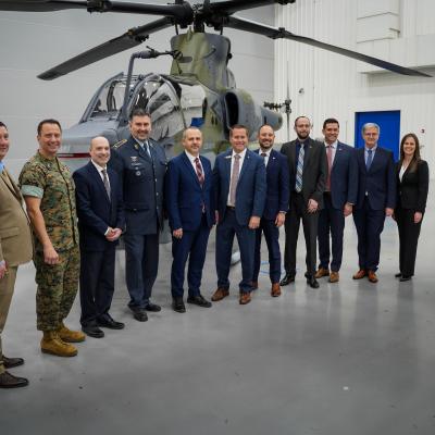 Various visitors from the Czech Republic Ministry of Defense, Naval Air Systems Command and Bell Textron pose for a photo with the recently unveiled AH-1Z Viper, the first designated to the Czech Republic Air Force.