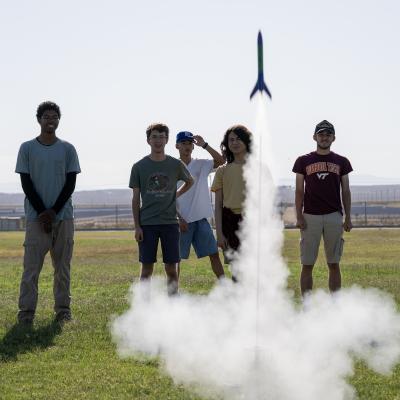 Students at Burroughs High School in Ridgecrest, Calif. watch a second rocket launch on May 29 after using painter’s tape to repair damage from a previous failed attempt. The STEM partnership with the Naval Air Warfare Center Weapons Division teaches students that failure can lead to learning. (U.S. Navy photo by Ryan Smith)