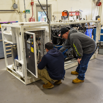 Team members work on a piece of cryogenic equipment at NAWCAD Lakehurst