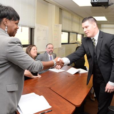 Mock interview participants shake hands