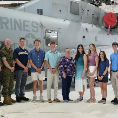 Students and adults in front of a CH-53K 