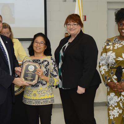 WILDWOOD, Fla. (May 10, 2019) John J. Daly, President of the Central Florida Federal Executive Association presents Mong Trang "T'Ann" Perrault from the NAWCTSD Contracting Office with the association's Federal Employee of the Year Award for Stewardship. The awards ceremony held during Public Service Recognition Week honored the contributions of federal employees throughout Central Florida.  