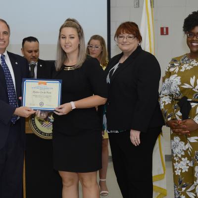 John J. Daly, President of the Central Florida Federal Executive Association presents NAWCTSD Management Analyst, Kimber De La Rosa with the association's Federal Employee of the Year Honorable Mention in the Valor Category. 