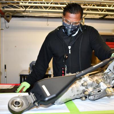 Man assembles H-53 helicopter primary servo cylinder