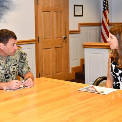 FRCE commanding officer and North Carolina Secretary of the Environment hold discussion at end of conference table