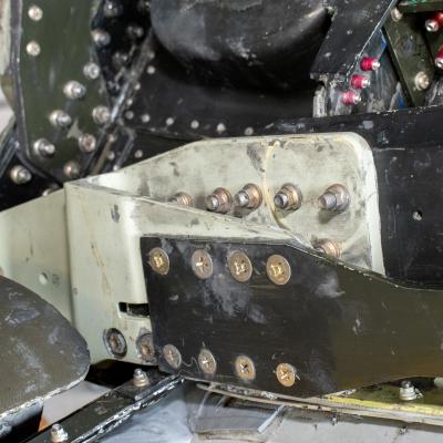 Close up image of green and tan aircraft part 