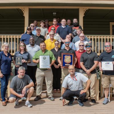 Group of people pose with awards 