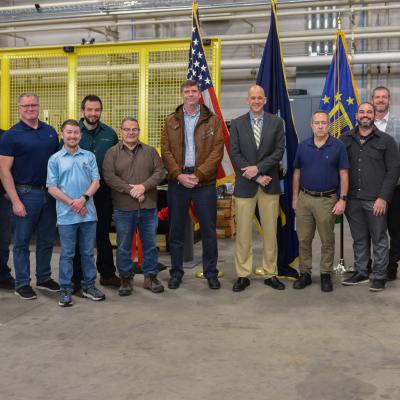 Leadership poses at ribbon cutting for new testing equipment