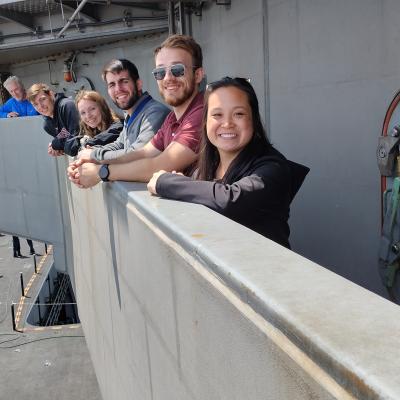 Team members pose on ship trip