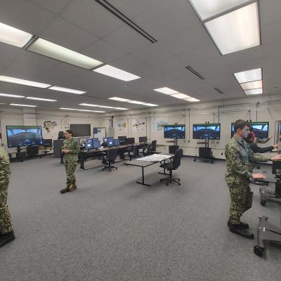 Sailors in a classroom training conducting training using virtual touch-screens