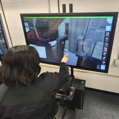 Sailor in black shirt training on a virtual touch-screen