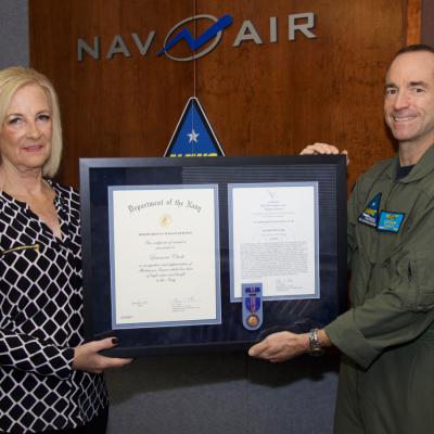 Lea Clark receives a Navy Meritorious Civilian Service Award from Rear Adm. Scott Dillon, Naval Air Warfare Center Weapons Division commander, during a Nov. 9 ceremony at China Lake. (U.S. Navy photo released)