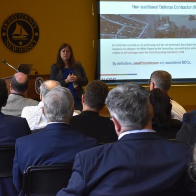 Naval Aviation Systems Consortium representatives brief industry day audience