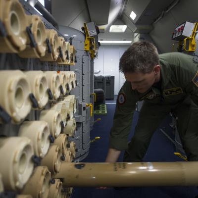 Sailor loads a sonobuoy aboard a P-8