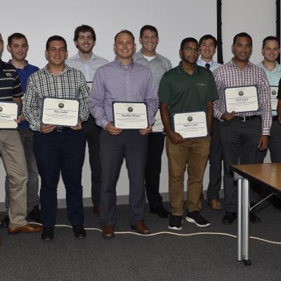 The Professional Develop Group poses for a group photo with award certificates