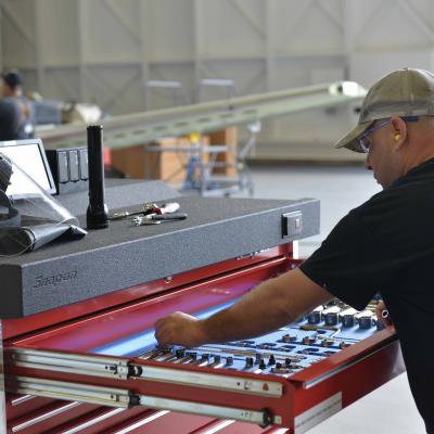 Fleet Readiness Center Southeast aircraft mechanic Tom Fotos pulls a tool out of the new electronic toolboxes.