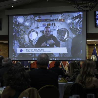 Astronaut Barry Wilmore floats while he delivers remarks onboard the International Space Station.