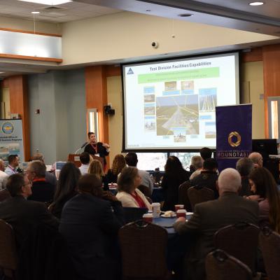 Audience listens to speaker at industry day