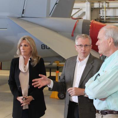 Harlan Kooima, center, Software and Mission Systems Integration Department director, highlights some of the work that goes on in the NAWCWD Advanced Weapons Integration and Interoperability Lab to Secretary of the Navy Richard Spencer during his visit to China Lake on Nov. 17 as NAWCWD Executive Director Joan Johnson looks on. (U.S. Navy photo by Aaron Crutchfield)