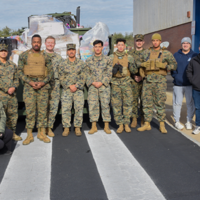 NAWCAD Lakehurst team members pose with Marines during the annual Toys for Tots drive.
