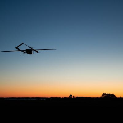 An autonomous vehicle - dubbed Blue Water Maritime Logistics UAS - flies over Unmanned Air Test and Evaluation (UX) 24 during a demonstration flight at NAS Patuxent River.