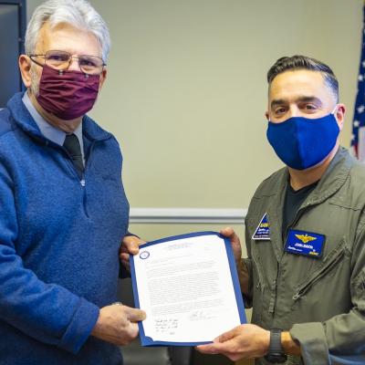 Rear Adm. John S. Lemmon, right, presents Tony Spadarella with the 2021 NAWCAD Patuxent River Mentor of the Year Award during a ceremony at the VX-20 hangar on Feb. 8.