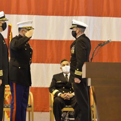 An incoming commanding officer salutes during a change of command ceremony.