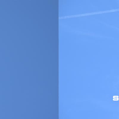 Two unmanned systems fly against blue skies.