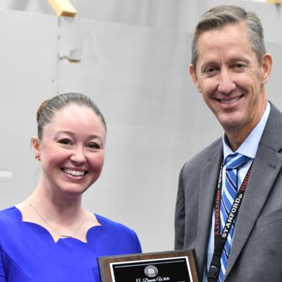 man and woman smiling holding an award