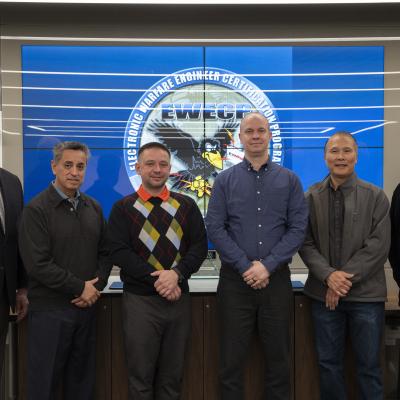 Electronic Warfare Engineering Certificate Program graduates, Pavel Rybakov (third from left) and Michael Fischer (third from right), pose with the program leaders and training coordinator in honor of their completion of the four-year curriculum during a ceremony in China Lake on Jan. 21. 