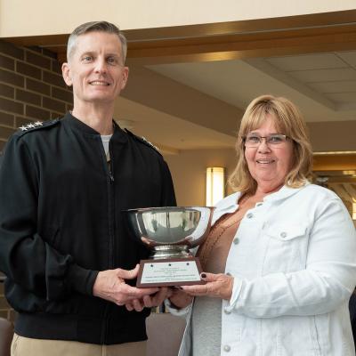 Command Re-utilization and Disposal team lead Michele Maples accepts the NAVAIR Commander’s Award for Highest Impact Reduction in Business Transactions from Vice Adm. Dean Peters, NAVAIR commander, during a ceremony March 10 at Naval Air Station Patuxent River. (U.S. Navy photo by Peter Fitzpatrick)