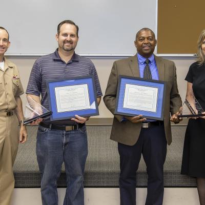 Rear Adm. Scott Dillon, left, NAWCWD commander, and Joan Johnson, right, NAWCWD executive director, pose with CDR Clifton Evans Jr. Memorial Award winners Sean Husband and Lawrence Deshotel during the Honorary Awards Ceremony in Point Mugu, California, on June 27. Award recipient Mark Roth was unable to attend. (U.S. Navy photo by Rob Grabendike)