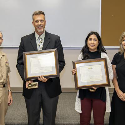 Rear Adm. Scott Dillon, left, NAWCWD commander, and Joan Johnson, right, NAWCWD executive director, pose with Michelson Laboratory Award winners Sylvia Gonzalez and Steven Sanders during the Honorary Awards Ceremony in Point Mugu, California, on June 27. Award recipients Damon Green and David Woodbury were unable to attend. (U.S. Navy photo by Rob Grabendike)