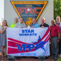  FRCE safety leaders stand with the new VPP flag.