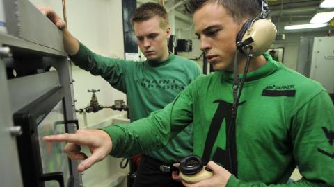 Sailors work on advanced recovery control panel aboard 