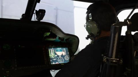 A pilot performs a simulated shipboard-landing maneuver through fog in a virtual scenario at the Naval Air Warfare Center Aircraft Division’s Manned Flight Simulator in Patuxent River, Md. 