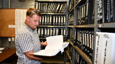 Data management technician edits technical manual.