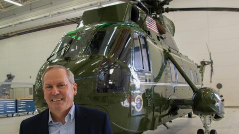 Glenn Perryman, deputy program executive officer for Air Anti-Submarine Warfare, Assault, and Special Mission Programs, stands in front of Sikorsky NVH-3A Sea King BuNo 150614, which his father flew as commanding officer of Marine Helicopter Squadron (HMX) 1. The helicopter subsequently served Air Test and Evaluation Squadron (HX) 21 as a testbed for 32 years before making its last flight in October 2020.