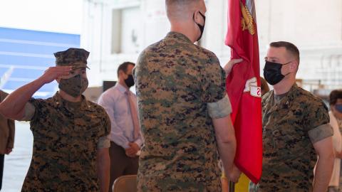 Col. Brian Taylor (left) relieves Col. Matthew Kelly (right) as the program manager of the V-22 Joint Program Office (PMA-275) during a change of command ceremony at Naval Air Station Patuxent River Apr. 29. Lt. Col. Jason Duke, master of ceremonies, salutes during the passing of the colors. 