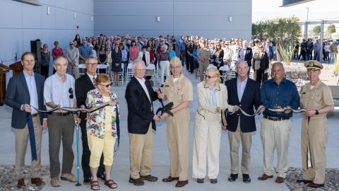Naval Air Warfare Center Weapons Division Commander Rear Adm. Keith Hash, center right, and Alexander Rogers, Dr. Peggy Rogers’ son, center left, pose after cutting the ribbon on NAWCWD’s newest laboratory, the Dr. Marguerite “Peggy” Rogers Lab in China Lake, California, on Oct. 24. 