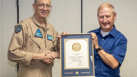 Ken Ewbank, right, poses with Rear Adm. Keith Hash, Naval Air Warfare Center Weapons Division Commander, after receiving his 45-year Length-of-Service Award in a ceremony July 14 in China Lake, California. (U.S. Navy photo by Ryan Smith)