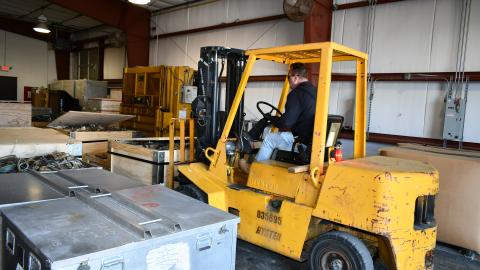 Forklift removes parts from warehouse